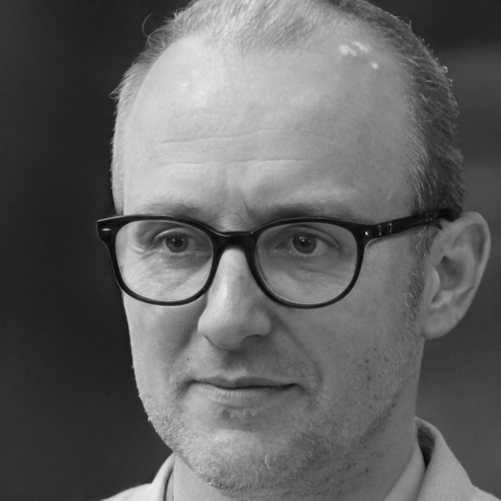 Professional headshot of Darius Kowalczyk